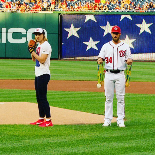 Katie Ledecky had Bryce Harper hold all of her medals while she threw out the first pitch