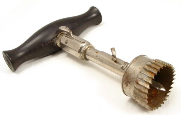 The trephine was a hand-powered drill used in the 1800's.
The spikes in the cylinder was used to hold the blade in place while the middle blade cut into the skull.