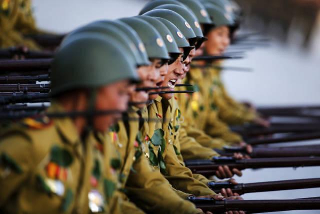 Soldiers yell slogans in a military display for leader Kim Jung Un and others at the 70th anniversary of the Worker's Party.