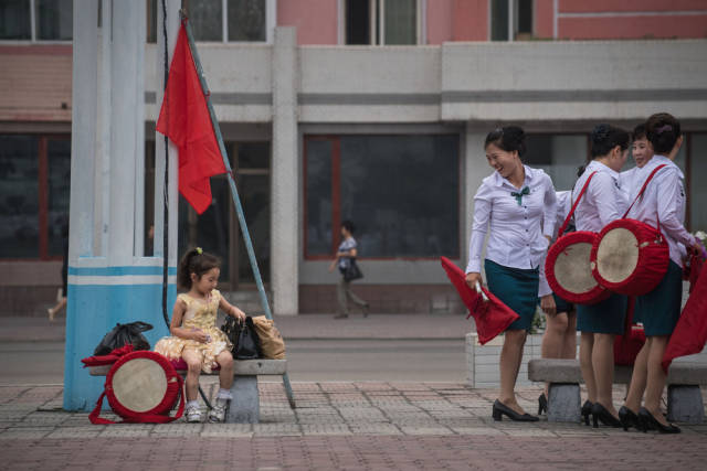 A local troupe prepares to put on a propaganda display in support of a new government-led economic plan.