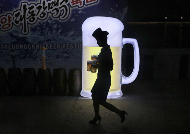 Occasionally, you will see ads for things like beer and other products. Here’s a woman walking in front of one such sign during a beer festival in Pyongyang.