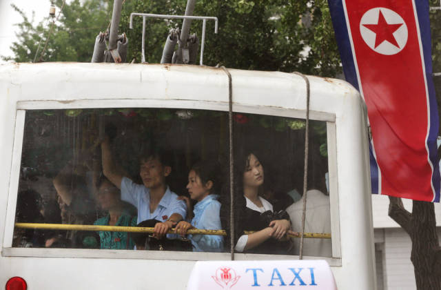 Here, people ride on a trolley during the celebration of "Military First" holiday (notice a theme?) that will also feature concerts, dancing, and exhibitions to celebrate successful missile tests.