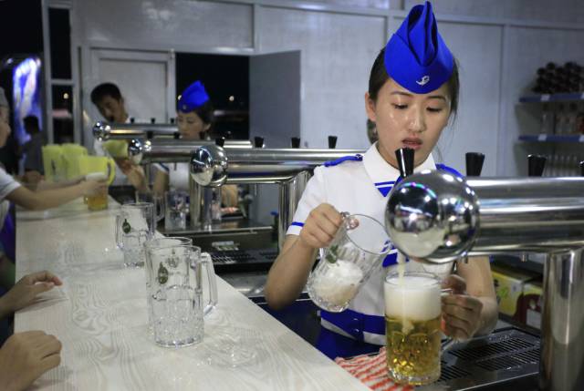 A server fills beer orders at a beer festival held in Pyongyang.