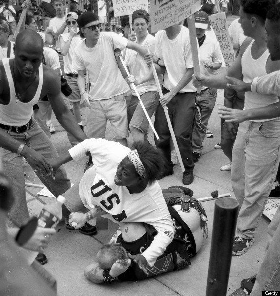 Keshia Thomas, 18, protects a white supremacist from an angry mob. [1996]