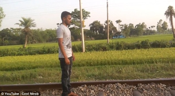 What this adrenaline-seeker did in Bangladesh is straight-up insane. He patiently stands on train tracks, awaiting a swift demise. Just seconds before impact, he lies down on his stomach, and after the train thunders past (mere inches from his head), he casually checks himself for injuries, jumps up, collects his camera and runs off.

While the whole thing is pretty amazing, it could have ended an entirely different way. He could have killed himself and possibly hundreds of others. Basically, just stay away from train tracks, everyone.