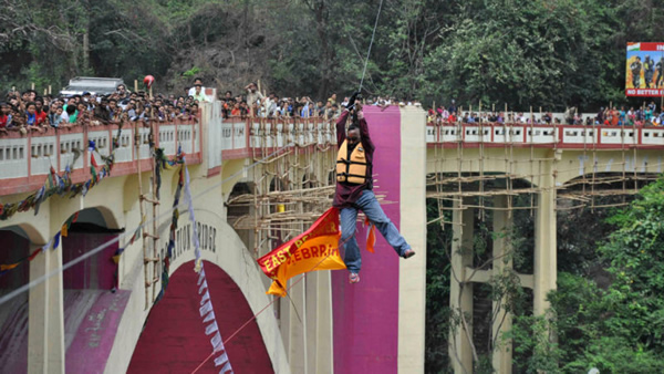 A daredevil known for setting the world record for longest distance traveled on a zip line while tethered by his hair died in 2013 while attempting to recreate the stunt over the River Teesta in the east Indian state of West Bengal.

Eyewitnesses say Sailendra Nath Roy, 48, made it about halfway across the 600-foot wire when his ponytail apparently became entangled in the wheeler leaving him dangling some 70 feet above the river while spectators watched helplessly. Because the stunt was performed illegally — and Roy had no emergency personnel standing by to assist him — it took another 45 minutes before police were finally able to bring him down. He was rushed to a nearby hospital when doctors pronounced him dead of an apparent heart attack.