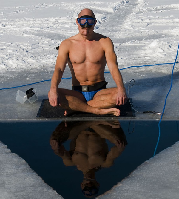 Danish freediver Stig Severinsen — who has a Ph. D. in medicine and a master's degree in biology — is known for participating in the most extreme challenges, including swimming in freezing water. Before setting his first breath-holding world record, he swam 500 feet (about 152 meters) in the sub-zero waters of the North Sea. 

After taking a few breaths of air, he dived feet first through a hole carved in the ice. As soon as he was in the water, he started swimming to the next hole wearing only in his signature blue Speedos. It was 152 meters away, and there wasn't another escape route, which made the challenge extremely dangerous. After reaching his destination in just 2 minutes and 11 seconds, the 40-year-old daredevil lingered in the freezing hole a little longer, as if to prove the cold didn't affect him much.

He also set another record for swimming 72 meters wearing only swimming trunks. You'd think that after swimming that distance in the heart-stopping water he would immediately jump out to find some warm clothes, but our hero just stood there with his elbows on the ice, smiling and thanking everyone as if he was in a hot tub or somewhere in the Bahamas.