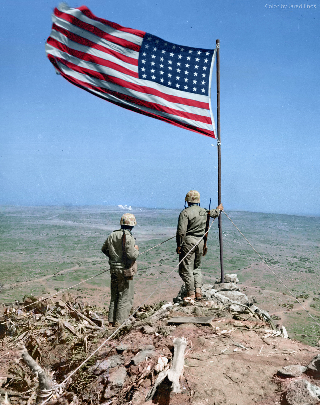 Two US Marines look over Iwo Jima from atop Mt. Suribachi, where just two days before, the US flag was famously risen. February 25, 1945