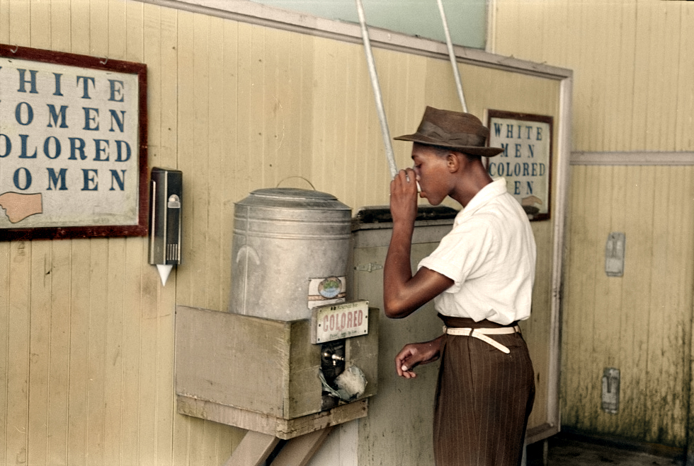“Negro drinking at ‘Colored’ water cooler in streetcar terminal, Oklahoma City, Oklahom” ca. July 1939