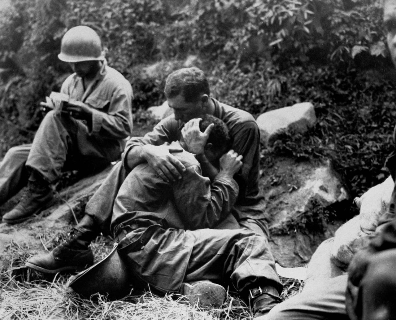 A grief-stricken American infantryman whose buddy had just been killed is comforted by a fellow soldier 1950.