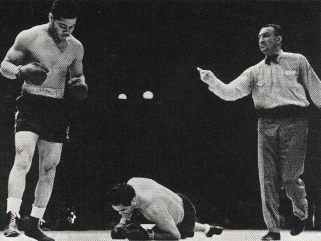 Joe Louis stands over Max Schmeling in the World Heavyweight Championship boxing match on June 22, 1938.

The fight took on a fiercely political tone; Franklin D. Roosevelt and Adolf Hitler had each openly visited his respective countryman before the fight, and a worldwide audience viewed the bout as a symbolic battle between America and Nazi Germany.
“It had tremendous political implications in the battle of democracy against fascism,” says Lewis Erenberg, author of “The Greatest Fight of Our Generation, Louis vs. Schmeling.” “And it had tremendous implications about race and racial ideology.”
Having repaired the faulty post-jab, left-hand drop that Schmeling had exploited in their first meeting, Louis quickly laid into his stunned opponent with a barrage of quick, close jabs. Clearly outmatched, Schmeling was unable to connect more than two punches in the entire fight, falling to the mat four times.
“A towel from Schmeling’s corner fluttered into the ring and referee Arthur Donovan, after first flinging the towel back towards the press section where it caught on the ropes, hanging as limply as the prone form of Schmeling in front of him, finally called a finish to the fight at just 2:04 of the first round,”
