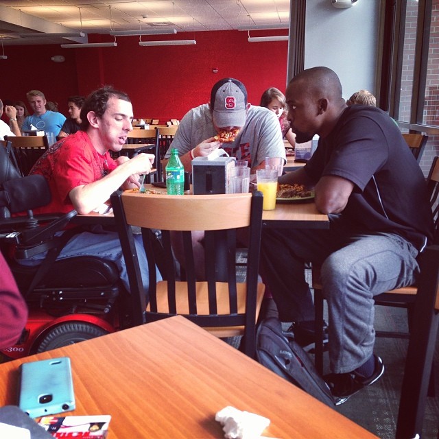 North Carolina State Football Players Join Student Eating Lunch Alone