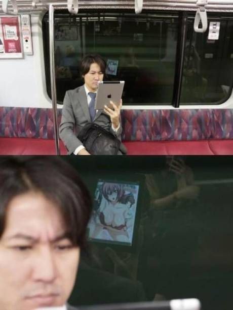 guy on train looking at hentai