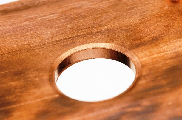 Create a useful cutting board drawer by drilling a circular hole in the board and putting a waste container underneath.