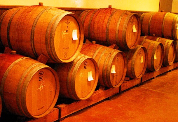 By removing part of the side of a wine barrel, you can create and decorate a baby cradle. Stabilize it by securing it with ropes to the ceiling or creating your own base. Just make sure there is no wine left in it.