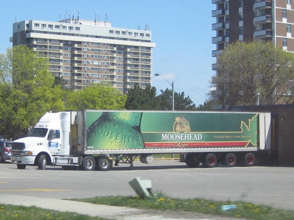 Then, there’s the Smokey and the Bandit styles of highway beer thefts.
In this case, someone went after our other national treasure – Beer! Back in 2004, a truck full of Moosehead Beer was ‘misplaced’ on it’s way to Mexico. The empty truck was later found in a New Brunswick McDonalds parking lot, while the driver was apprehended in Ontario.
The Police began looking for the 60,000 cans of beer, which were easy to distinguish due to the Spanish labels. Cans were found all over New Brunswick; at campgrounds, in various pulled over trucks, at a weed grow op, and they even found some in the forest, empty with bear bite marks in them.