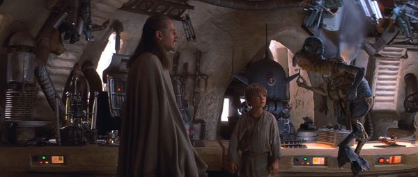 Star Wars Ep 1 – The Phantom Menace.
The script explains that the reason Watto is always flying is that he is crippled. Look closely, and you can see that one foot is longer than the other. He also talks out of the side of his mouth because the broken tusk slurs his words.