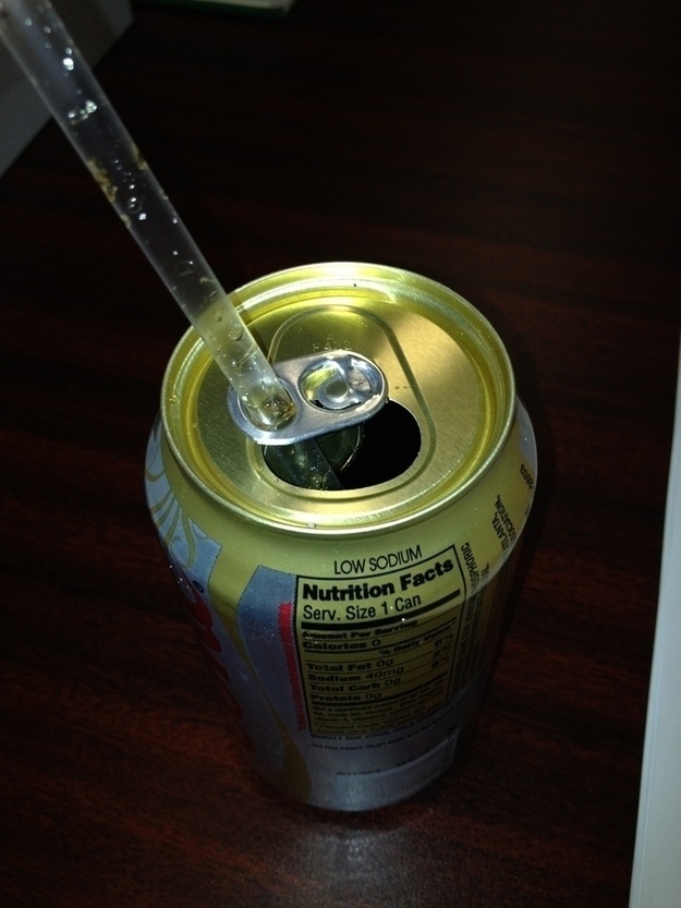 Soda Cans.
That little tab around the top of soda cans was designed to hold your straw. Simply twist the tab around, and center your straw and you're done.