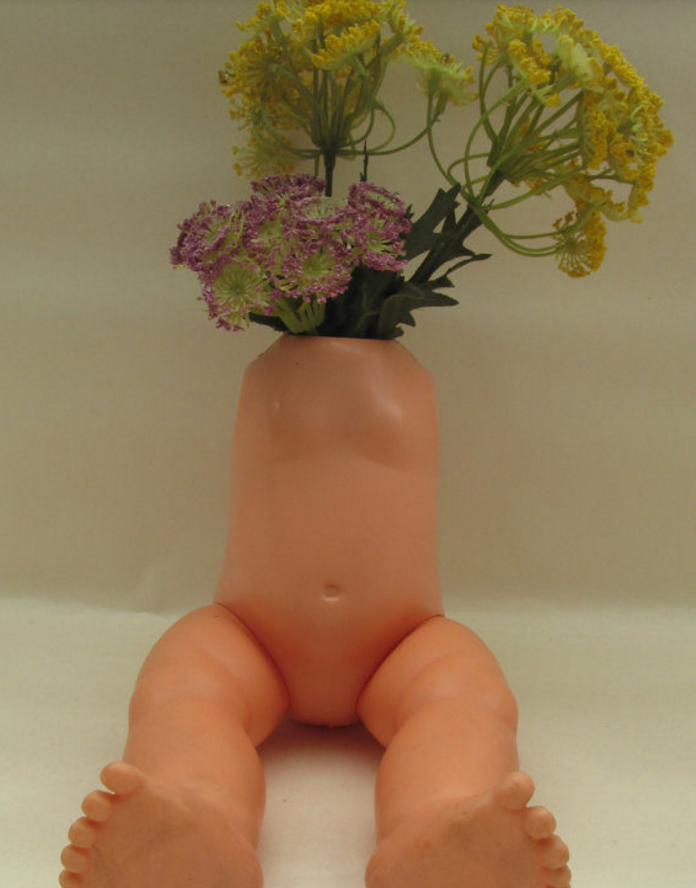 Flowers look so much prettier when they're placed inside doll torsos.