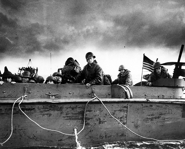 Troops and crewmen aboard a Coast Guard manned LCVP get ready to storm the Normandy beaches. June 6th, 1944
