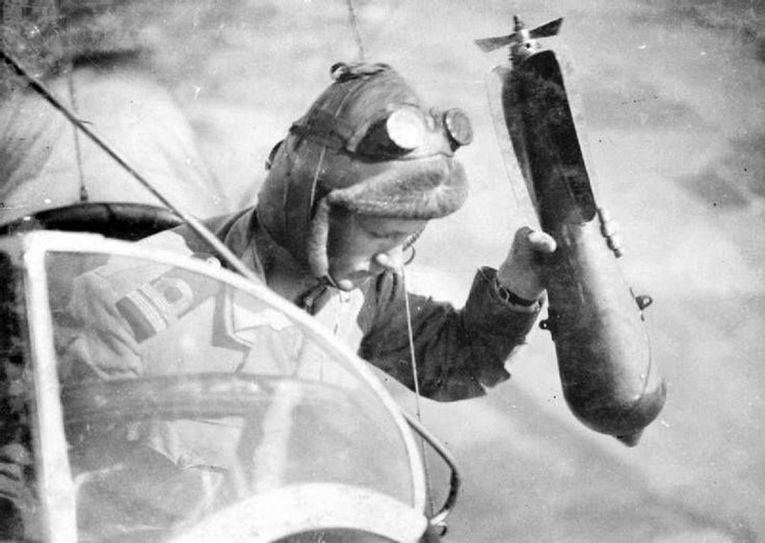 An english military aviator dropping a bomb during a flight on the French front during World War 1, c. 1916