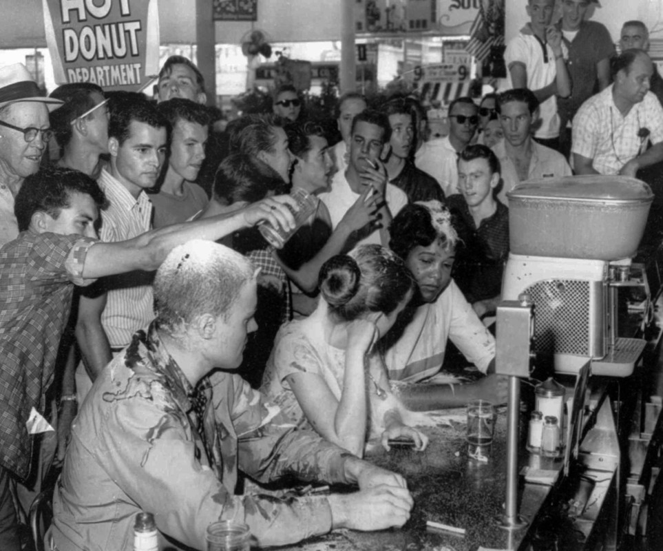 Sit-in demonstration at a Woolworth’s whites-only lunch counter in Jackson, Mississippi, turned violent when a mob poured sugar, ketchup and mustard over the heads of demonstrators, from left, John Salter, Joan Trumpauer and Anne Moody. May 28, 1963