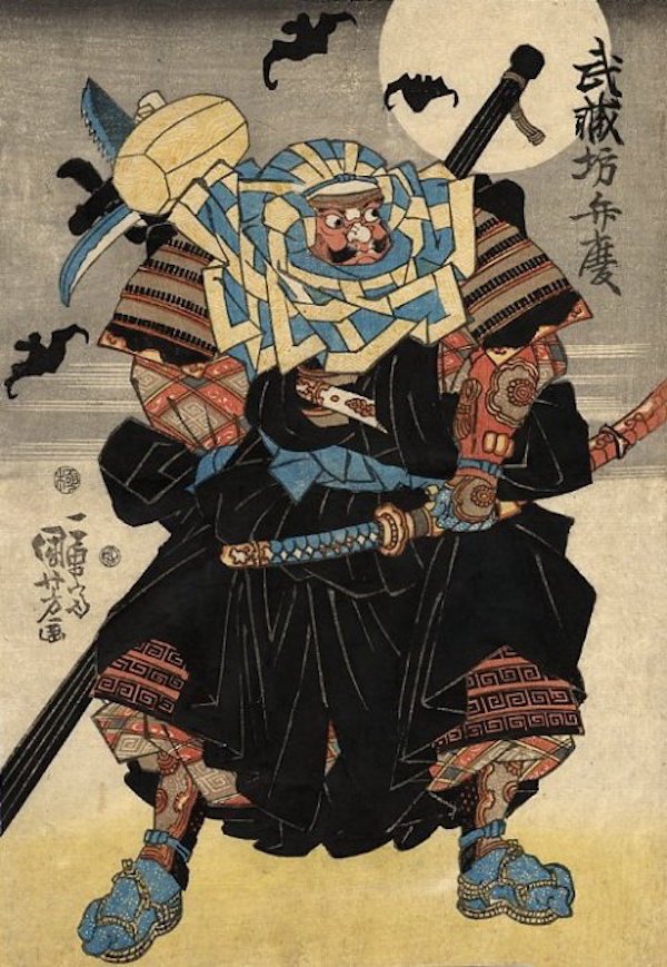 Saito Musashibo Benkei.
You may find it hard to believe that a Buddhist priest would end up earning the nickname ‘The Demon-Child’ in his life, but allow us to fuck you up with some truth. Saito Musashibo Benkie was a massive 6-foot-5 professional shit-wrecker with a face that resembled a Halloween mask and an attitude that makes Nancy Grace seem like that sweet little lisp-talking dinosaur in The Land Before Time. After leaving the monastery, he lived a quaint life of murder-killing men (around 300) and stealing their swords, until one day he was bested by a man named Minamoto no Yoshitsune. Despite being a psychopath of the highest degree, Benkei had a profound sense of loyalty and asked if he could serve the man who bested him, Yoshitsune, until his death. He accepted Benkei’s offer.
Benkei slung his enormous balls over his shoulder (we’re guessing) and proceeded to the drawbridge where he basically reenacted a scene you’d see in Doom. Realizing no one in the army was going to best someone in hand-to-hand combat while they had god-mode on (IDDQD!), they decided it was wisest to kill him from a distance with a mess of arrows. Much to the horror of the army, Benkei remained unfazed by the arrows. How? Benkei died standing and the arrows that pierced his legs pinned him up in place like some sort of murder scarecrow. By the time they figured it out and crossed, Yoshitsune had gone through with the act.