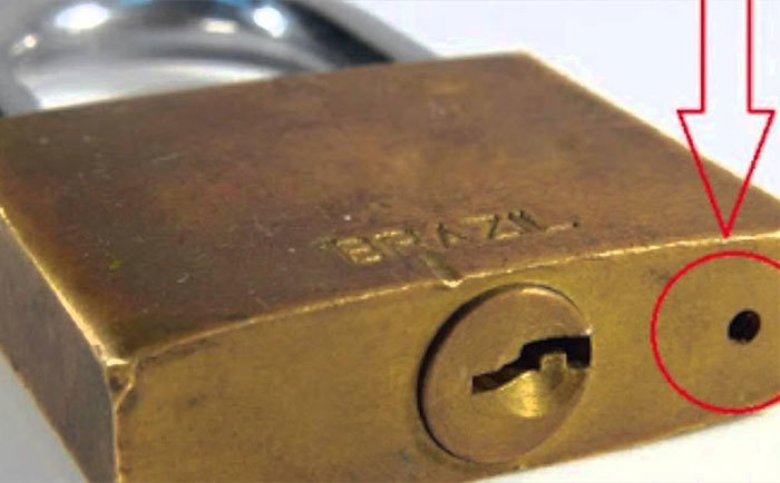 The Hole at the Bottom of Padlocks.
These little holes are for drainage and lubrication purposes. Take care of your padlocks and you won't have to buy a new one for years.