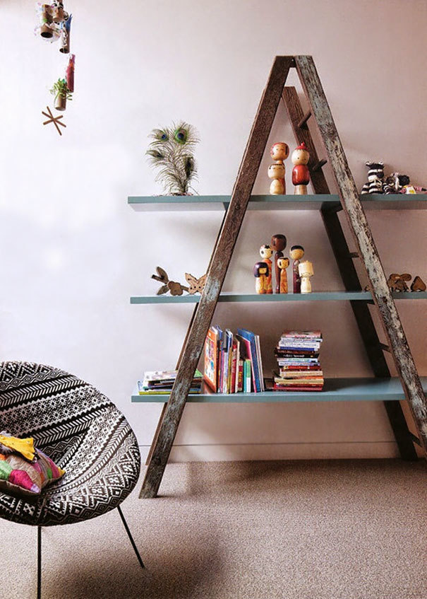 Transform an old ladder into a cool looking rustic bookshelf by adding panels on three different levels of the ladder.
