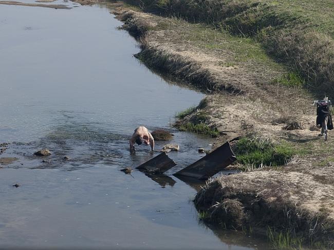 Bathing in the river is common and portrays poverty.