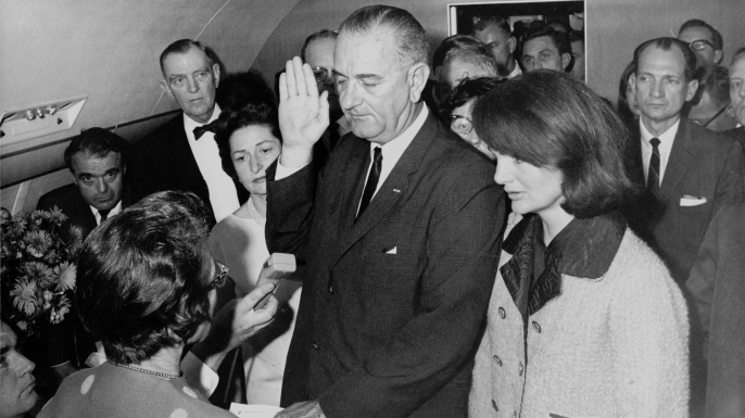 Lyndon Johnson, 1963, Air Force One.
Two hours after President John F. Kennedy was assassinated on November 22, 1963, Vice President Lyndon Johnson was sworn in as the nation’s 36th president aboard Air Force One at Dallas’ Love Field. Cecil Stoughton, a former Army photographer who had served as the official White House photographer since 1961 (the first person to hold the post), took the historic photo of Judge Sarah Hughes administering the oath of office to a solemn Johnson, flanked by his wife, a group of staffers and a stunned-looking Jaqueline Kennedy, still clad in the pink Chanel suit she was wearing when her husband was shot.
At the time of Kennedy’s assassination, Stoughton was riding several cars behind the president as part of his motorcade. Afterward, Stoughton went to Parkland Hospital, where Kennedy died, then raced to Love Field for Johnson’s swearing-in. Stoughton was the only photographer on the plane when Johnson was inaugurated and initially, when his camera malfunctioned, it appeared there wouldn’t be any photographic record. However, he quickly fixed the problem and was able to document the event. In a chaotic time for America, Stoughton’s photograph demonstrated the country still had continuity of government.