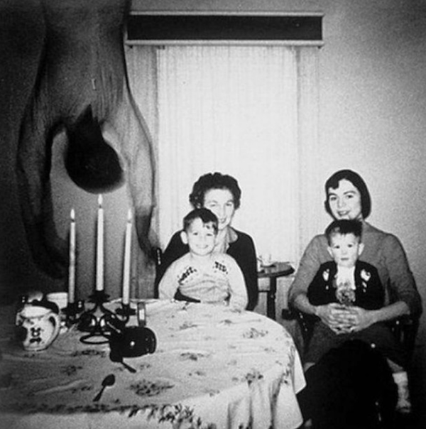The Coopers’ Family Photos.
In the 1950’s the Cooper family from Texas, moved into a new home and wanted to commemorate the move with a photo. When the image was developed, there was this body/ghost falling from the ceiling, captured in the photo. Analysis of the negative yielded nothing. It literally looks like a ghost took that particular moment to fall from the ceiling and add themselves to the family shot.