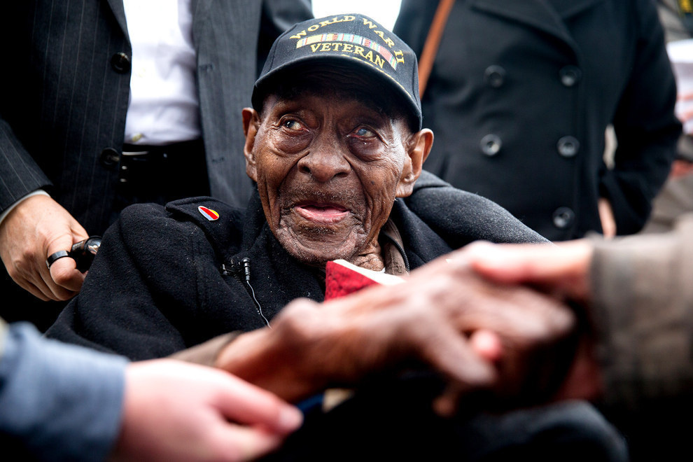 Frank Levingston Jr., being greeted by visitors at a ceremony for the anniversary of Peal Harbor as he is America's oldest military veteran at the age of 110.