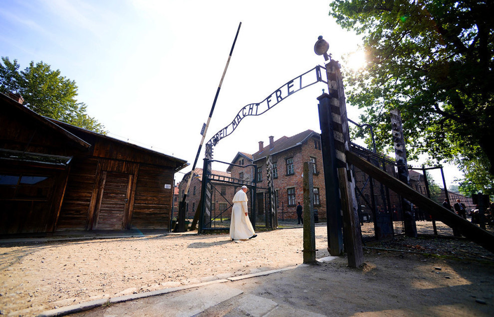 Pope Francis taking a walk through the gate of the former Nazi death camp of Auschwitz, becoming the third consecutive pontiff to visit the camp where Adolf Hitler's men killed over a million people.