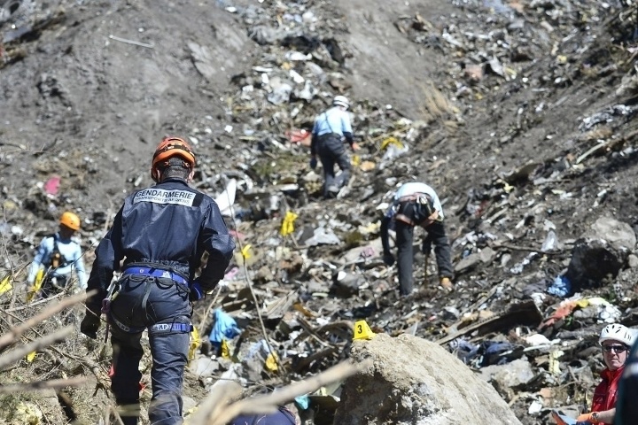 Rescue workers searching the site of the Germanwings plane crash near the French Alps after the plane's co-pilot intentionally crashed the plane, killing all 150 people on board.