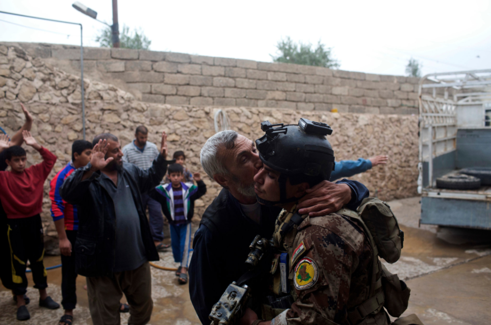 A man kisses an Iraqi special forces soldier as thanks after his neighborhood in Mosul is freed this week