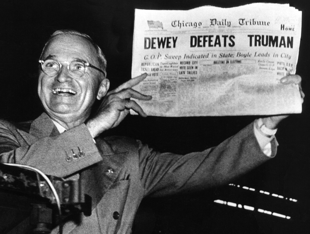 President Truman holding a newspaper that stated he lost after winning the election November 3, 1948