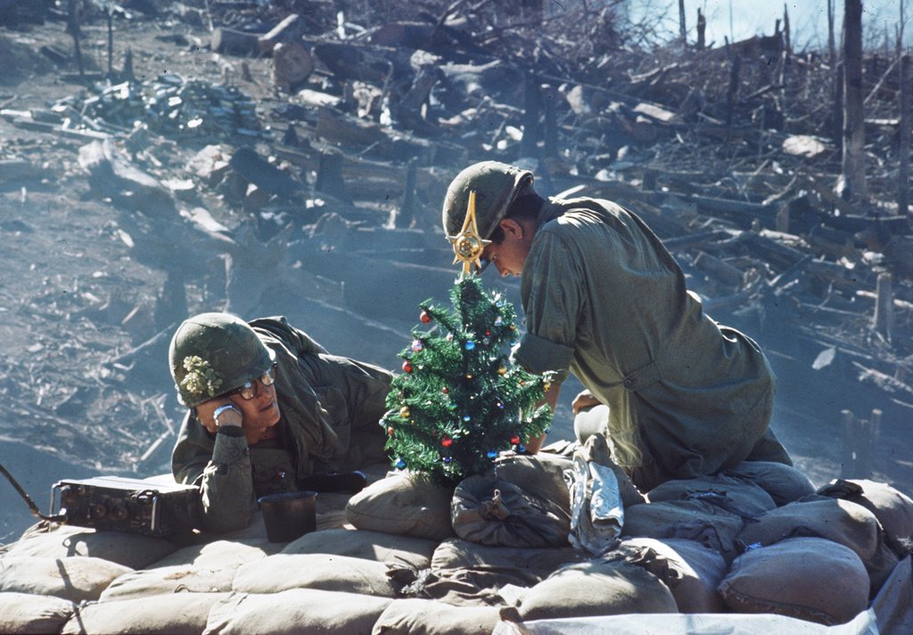 American soldiers rest near a small Christmas tree on Hill 875 near Dak To, Vietnam, 25 December, 1967