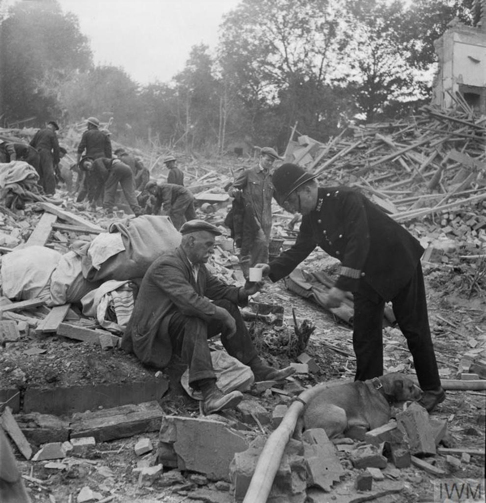 PC Frederick Godwin offers tea and sympathy to a now homeless man, who returned home from walking his dog to find his house destroyed and wife killed by a V1 flying bomb. London 1944