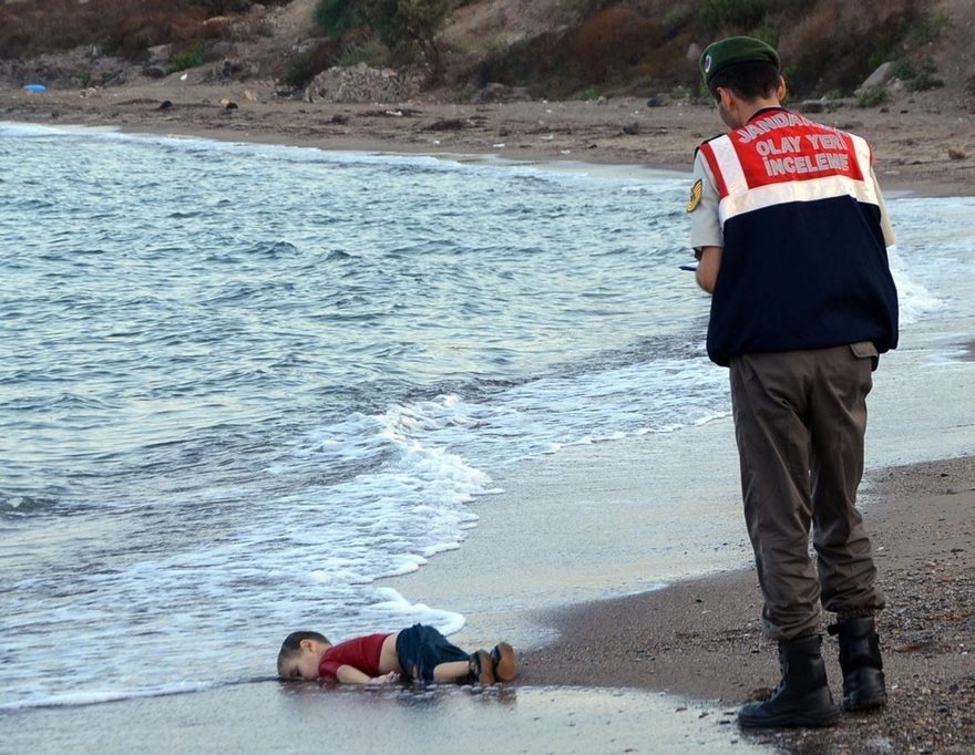 Aylan Kurdi, Nilüfer Demir, 2015.
Aylan Kurdi was a 2-year-old Kurd from Syria, and he was on his way to Greece, reports CTV. He was on a small boat with about a dozen other refugees from the Middle East when it capsized. His father, Abdullah Kurdi, is the lone survivor. The photographer, 29-year-old Nilüfer Demir, wanted the world to hear their silent screams.