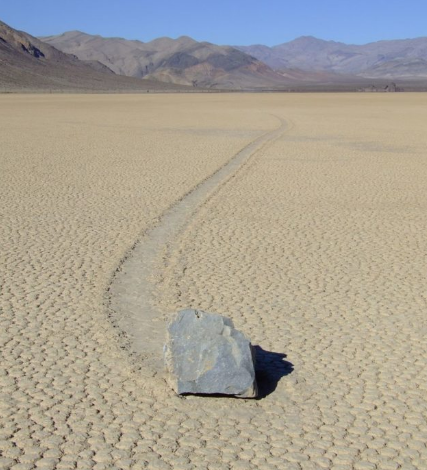 Sailing stones are rocks that seemingly move on their own, leaving long tracks behind them. However, this is caused by ice sheets on winter ponds breaking up and pushing the rocks as they are moved by the wind.