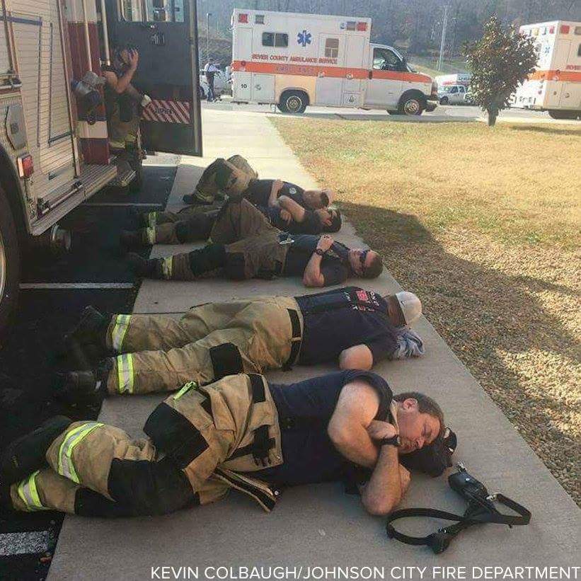 Firefighters napping after 30 hours of fighting Tennessee wildfire.