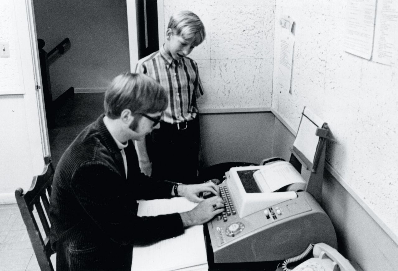 Microsoft founders Bill Gates(13) and Paul Allen(15) connect to a PDP-10 computer at the University of Washington, through a teletype terminal at their Lakeside School in Seattle in 1968.

Paul Allen describes meeting Bill Gates at the teletype machine:
One day early that fall, I saw a gangly, freckle-faced eighth-grader edging his way into the crowd around the Teletype, all arms and legs and nervous energy. He had a scruffy-preppy look: pullover sweater, tan slacks, enormous saddle shoes. His blond hair went all over the place. You could tell three things about Bill Gates pretty quickly. He was really smart. He was really competitive; he wanted to show you how smart he was. And he was really, really persistent. After that first time, he kept coming back. Many times he and I would be the only ones there.

Bill came from a family that was prominent even by Lakeside standards; his father later served as president of the state bar association. I remember the first time I went to Bill’s big house, a block or so above Lake Washington, feeling a little awed. His parents subscribed to Fortune, and Bill read it religiously. One day he showed me the magazine’s special annual issue and asked me, “What do you think it’s like to run a Fortune 500 company?” I said I had no idea. And Bill said, “Maybe we’ll have our own company someday.” He was 13 years old and already a budding entrepreneur.

Where I was curious to study everything in sight, Bill would focus on one task at a time with total discipline. You could see it when he programmed—he’d sit with a marker clenched in his mouth, tapping his feet and rocking, impervious to distraction. He had a unique way of typing, sort of a six-finger, sideways scrabble. There’s a famous photograph of Bill and me in the computer room not long after we first met. I’m seated on a hard-back chair at the teleprinter in my dapper green corduroy jacket and turtleneck. Bill is standing to my side in a plaid shirt, his head cocked attentively, eyes trained on the printer as I type. He looks even younger than he actually was. I look like an older brother, which was something Bill didn’t have