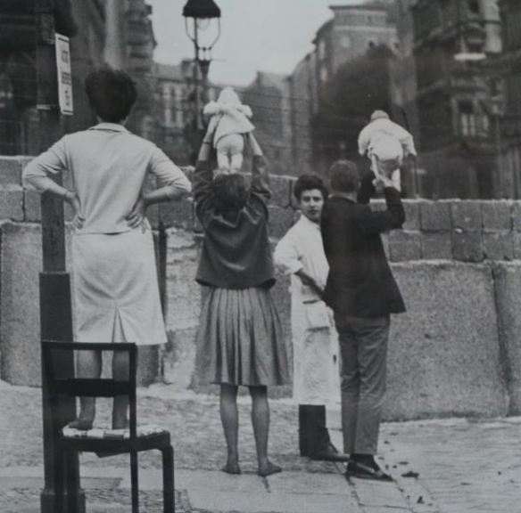 Residents of West Berlin show children to their grandparents who reside on the Eastern side, 1961.

The building of the Berlin Wall in August 1961 divided families and neighborhoods in what had been the capital of Germany. The Wall represented a uniquely squalid, violent, and ultimately futile, episode in the post-war world. Life was changed overnight in Berlin. Streets, subway lines, bus lines, tramlines, canals and rivers were divided. Family members, friends, lovers, schoolmates, work colleagues and others were abruptly separated. In some cases, children who had been visiting their grandparents on the other side of the border were suddenly cut off from their parents.
