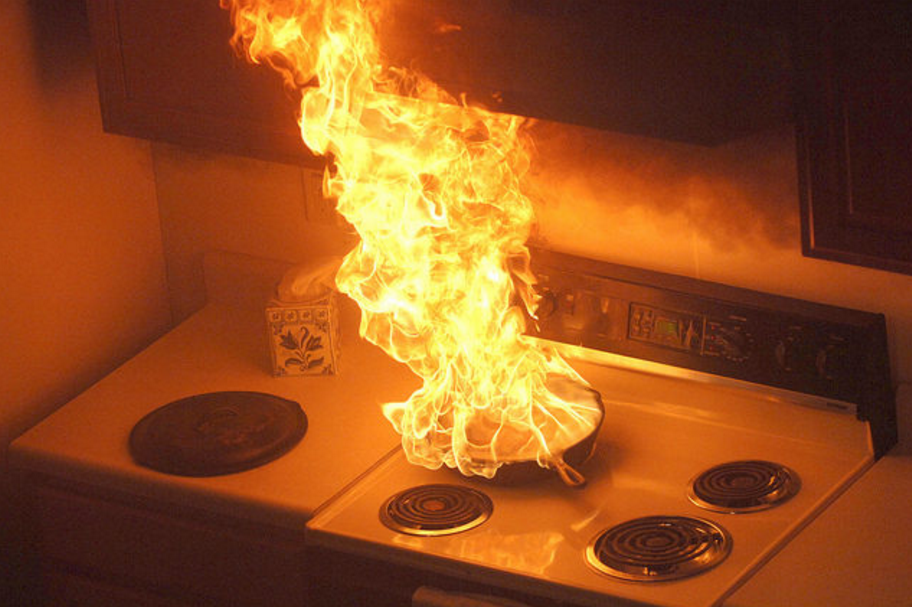 If cooking oil catches fire, turn off the burner and cover the pot. Cutting the heat and removing the oxygen will help reduce flames, whereas water will quickly evaporate and cause the flames to become stronger.