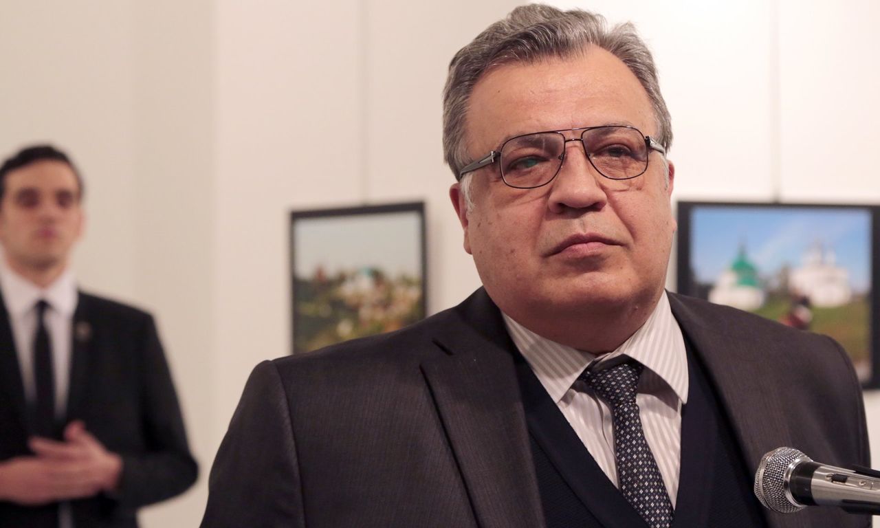 The Russian Ambassador to Turkey just moments before being assassinated by the man standing behind him