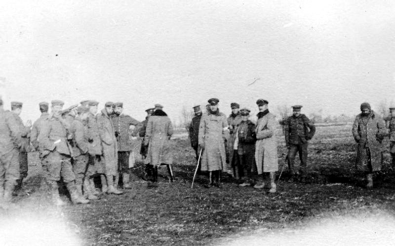 British & German soldiers of WW1 declare an informal truce and play a match of football between trenches, Christmas 1914