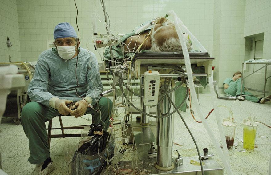 Heart surgeon after 23-hour-long (successful) heart transplant. His assistant is sleeping in the corner