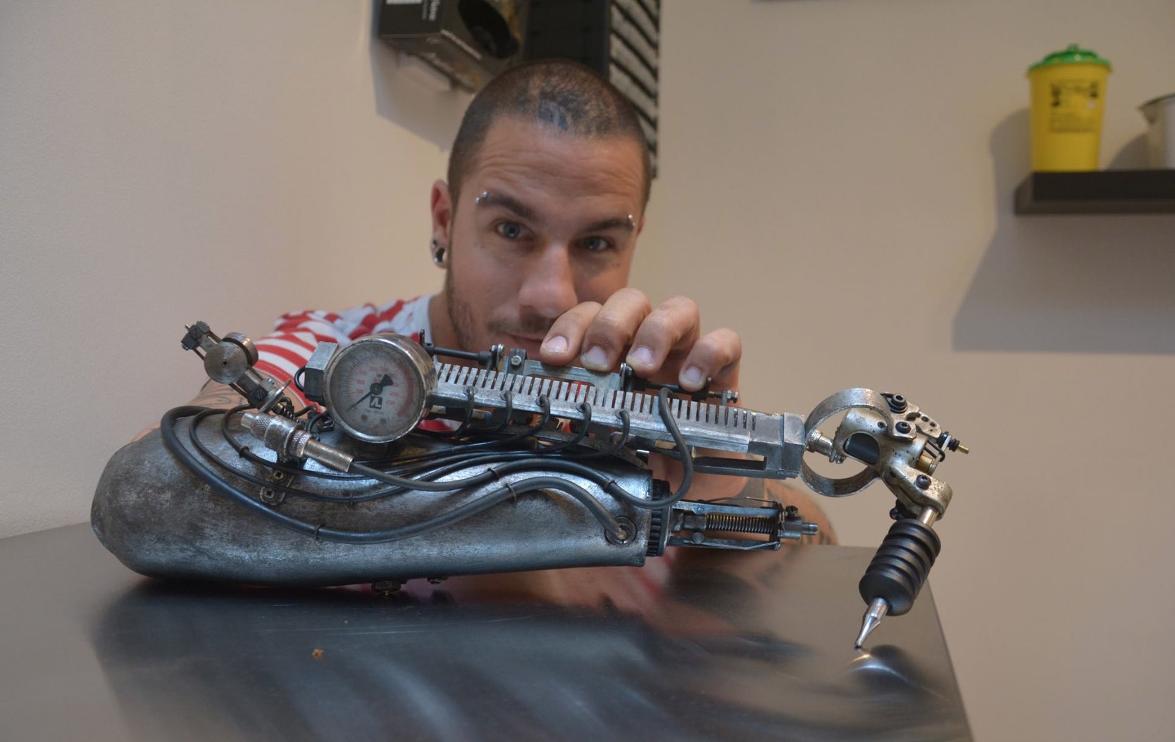 Since losing his arm, tattoo artist JC Sheitan Tenet uses a prosthetic arm that doubles as a tattoo machine