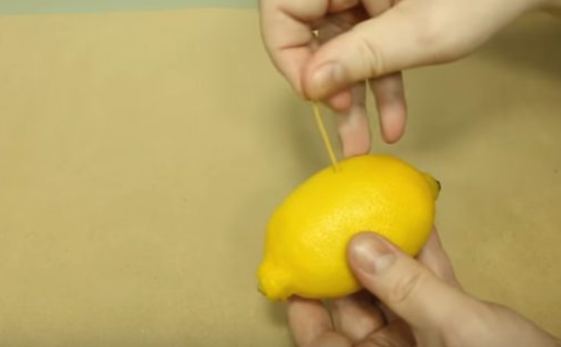 Use a toothpick to create a hole in a lemon and squeeze to get tart flavor in any dish without all the mess.